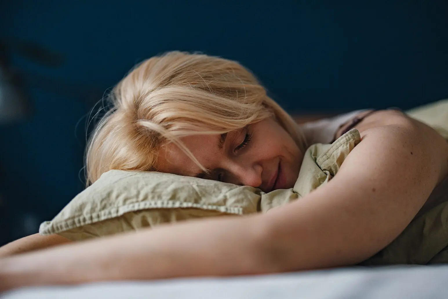 A lady with allergies struggling to get out of bed